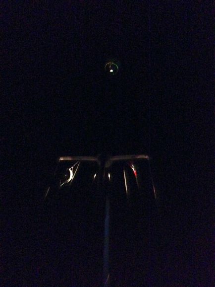 Here is a night shot of our mast.  You can see our halo on top, our radar reflector to port, and our Bahamian courtesy flag to starboard.