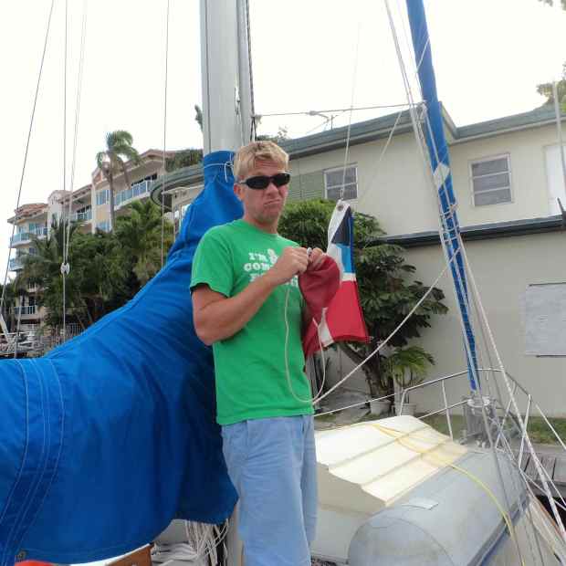 Jake takin' down our Bahamas flag once docked in Ft. Lauderdale.
